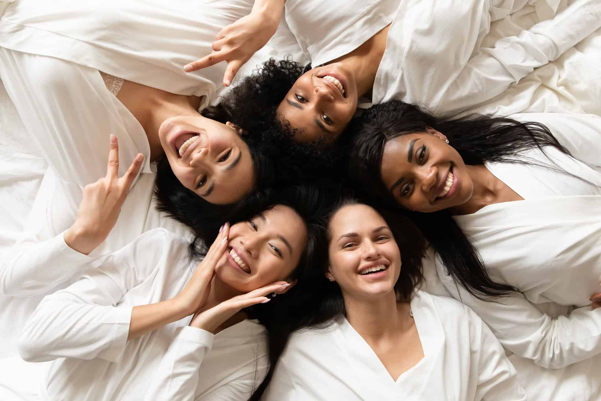 collagen-diverse-women-lying-in-bed-feels-happy