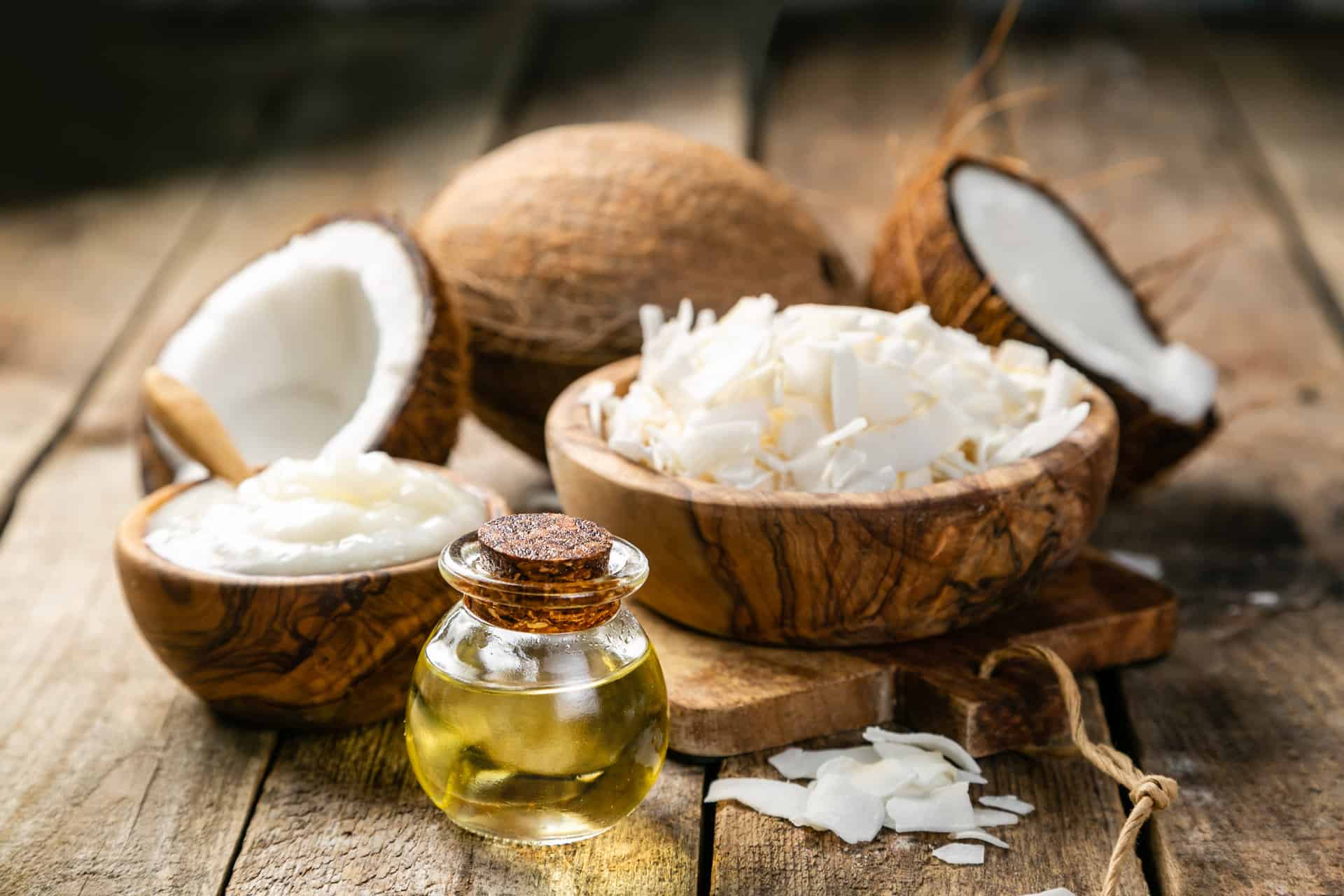 mct-oil-coconut-oil-concept-coconuts-butter-and-oil-on-wood-background