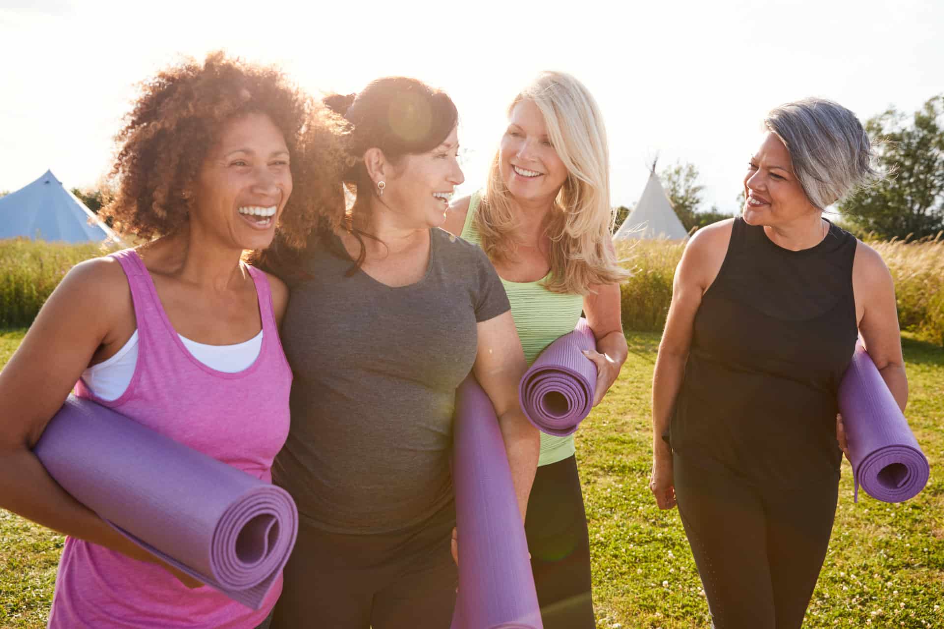 mct-oil-group-of-mature-female-friends-on-outdoor-yoga-retreat-walking-along-path